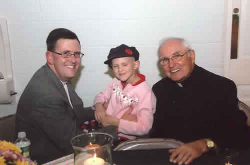 Catie at her fundraiser at St. James with Msgr. Capik and her dad