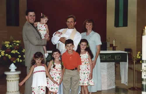 The O’Brien family and Fr. Keith at M.E.’s Baptism